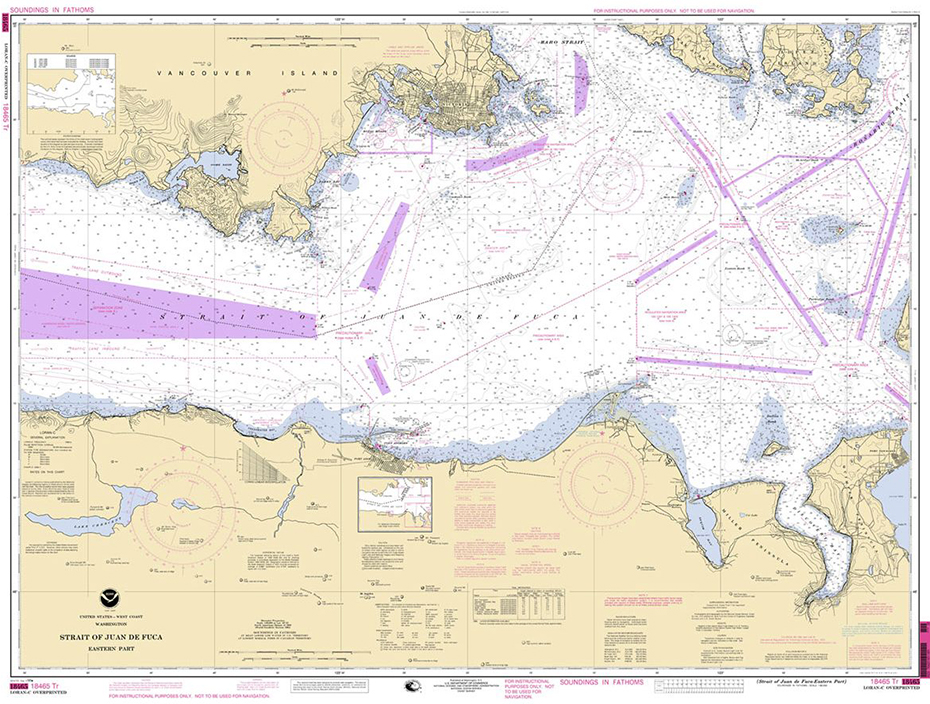 A paper nautical chart showing the Straight of Juan De Fuca with various navigational aids and features marked in purple lines.