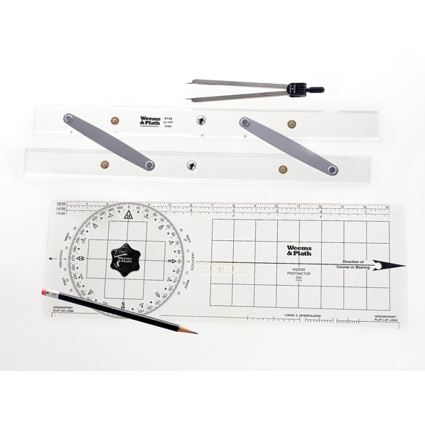 A collection of navigation tools including a protractor, parallel rule, dividers, a pencil, and sharpener spread out on a flat surface.